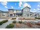 Inviting home with stone accents, a well-manicured lawn, and a charming covered front porch at 7484 W Atlantic Ln, Denver, CO 80227