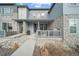 Charming townhome featuring a welcoming porch and stone accents at 7484 W Atlantic Ln, Denver, CO 80227