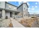 Inviting townhome boasts a cozy porch and attractive stone facade at 7484 W Atlantic Ln, Denver, CO 80227