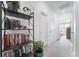 Bright hallway features a bookshelf with plants, books, and decorative lighting at 7484 W Atlantic Ln, Denver, CO 80227