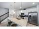 Well-lit kitchen featuring a large island, stainless steel appliances, and a convenient breakfast bar at 7484 W Atlantic Ln, Denver, CO 80227