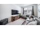 Cozy living room featuring a sectional sofa, TV, and a lovely wood entertainment center at 7484 W Atlantic Ln, Denver, CO 80227