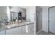 Large, bright main bathroom featuring a granite-topped vanity with double sinks and glass-enclosed shower at 7484 W Atlantic Ln, Denver, CO 80227