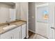 Bathroom with a vanity, mirror, and view to the bedroom at 869 Sawdust Dr, Brighton, CO 80601