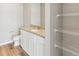 Bathroom with white cabinets and granite countertops with shelving for extra storage at 869 Sawdust Dr, Brighton, CO 80601