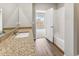 Bright bathroom featuring a granite countertop, white sink, and a view into the next room at 869 Sawdust Dr, Brighton, CO 80601