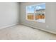 Cozy bedroom with a large window overlooking the backyard at 869 Sawdust Dr, Brighton, CO 80601