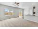 Spacious living room with natural light and open access to the backyard at 869 Sawdust Dr, Brighton, CO 80601
