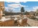 Inviting backyard with cozy seating area, wood storage shed, privacy fence, and outdoor dining at 6581 S Logan St, Centennial, CO 80121