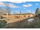 Wide-open backyard offering ample space for recreation with wooden patio set and a vintage tire swing at 6581 S Logan St, Centennial, CO 80121