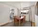 Bright dining room with hardwood floors, natural light, and a view to the kitchen at 6581 S Logan St, Centennial, CO 80121