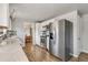 Open kitchen layout with stainless steel refrigerator and view into the dining room at 6581 S Logan St, Centennial, CO 80121