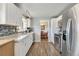 Well-lit kitchen featuring white cabinetry, granite countertops, and stainless steel appliances at 6581 S Logan St, Centennial, CO 80121