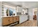 Charming kitchen with wooden sideboard, window with striped curtains, and stained glass accent at 6581 S Logan St, Centennial, CO 80121