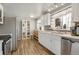 Well-lit kitchen featuring stainless steel appliances, white cabinets, and an undermount sink at 6581 S Logan St, Centennial, CO 80121