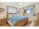 Cozy main bedroom with a wood frame bed and lots of natural light at 6581 S Logan St, Centennial, CO 80121