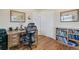 Home office with hardwood floors, a desk, an office chair, and built-in bookshelves at 6581 S Logan St, Centennial, CO 80121