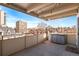 Balcony overlooking cityscape, with concrete floors, steel railing, and additional storage at 700 N Washington St # 502, Denver, CO 80203