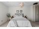 Neutral Primary bedroom with carpet, modern orb chandelier, and side tables with lamps at 700 N Washington St # 502, Denver, CO 80203