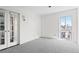 Bright bedroom with neutral carpet, double french doors, and window with a view at 700 N Washington St # 502, Denver, CO 80203