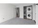 Bedroom featuring carpet floors, stacked washer and dryer, and adjacent bathroom access at 700 N Washington St # 502, Denver, CO 80203