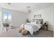 Bright bedroom features neutral decor, a large window, decorative lighting, and carpeted floors at 700 N Washington St # 502, Denver, CO 80203