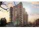 Apartment building featuring multiple floors and balconies, with parking and mature trees at 700 N Washington St # 502, Denver, CO 80203