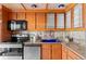 Charming kitchen with wood cabinets, stainless steel appliances, and unique backsplash at 700 N Washington St # 502, Denver, CO 80203