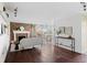 Spacious living room featuring hardwood floors, a brick fireplace, and natural light from the balcony at 700 N Washington St # 502, Denver, CO 80203