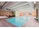Indoor swimming pool with brick accents, plenty of seating, and easy stair access at 700 N Washington St # 502, Denver, CO 80203
