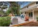 Charming back deck is perfect for entertaining, with comfortable seating and lovely plants at 8666 E Easter Ave, Centennial, CO 80112