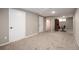 Finished basement with neutral walls and carpet, multiple doors and a desk with a chair at 8666 E Easter Ave, Centennial, CO 80112