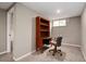 Finished basement office space with a built-in desk/bookshelf combo, a chair, and neutral walls at 8666 E Easter Ave, Centennial, CO 80112