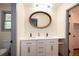 Well-lit bathroom featuring double sinks, modern fixtures, and ample vanity storage at 8666 E Easter Ave, Centennial, CO 80112