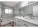 Beautiful bathroom featuring double sinks, marble tile, a glass shower door and neutral tones at 8666 E Easter Ave, Centennial, CO 80112