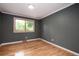 Bedroom features neutral paint and hardwood floors for a calm and restful retreat at 8666 E Easter Ave, Centennial, CO 80112