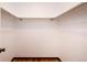 Bright walk-in closet featuring a wood floor and metal bars for hanging clothes at 8666 E Easter Ave, Centennial, CO 80112