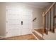 Welcoming entryway featuring wood floors, a staircase with wood banister and double doors at 8666 E Easter Ave, Centennial, CO 80112