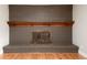 Stunning brick fireplace with a wooden mantle creates a cozy focal point in the living space at 8666 E Easter Ave, Centennial, CO 80112