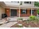 Close up of a brick home's entrance, showcasing the covered porch and detailed landscaping at 8666 E Easter Ave, Centennial, CO 80112