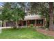 Charming two-story home with landscaped yard and a brick facade on a sunny day at 8666 E Easter Ave, Centennial, CO 80112