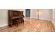 Bright living room with gleaming hardwood floors, a piano and plenty of natural light at 8666 E Easter Ave, Centennial, CO 80112