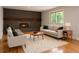 Inviting living room featuring a brick fireplace, hardwood floors, and comfortable seating at 8666 E Easter Ave, Centennial, CO 80112