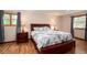 Serene main bedroom featuring hardwood floors, windows, and a comfortable bed at 8666 E Easter Ave, Centennial, CO 80112