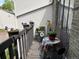 Cozy balcony featuring flower pots on the railing and a table with chairs, perfect for outdoor relaxation at 3550 S Harlan St # 174, Denver, CO 80235
