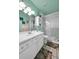 Bright bathroom with a white vanity, a framed mirror, and a glass-enclosed shower, providing a clean aesthetic at 3550 S Harlan St # 174, Denver, CO 80235