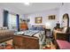 Inviting bedroom showcasing a wooden bed frame, matching dresser, and cozy window seating area at 3550 S Harlan St # 174, Denver, CO 80235
