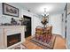 Cozy dining area featuring a fireplace, wooden table with chairs, and a decorative rug at 3550 S Harlan St # 174, Denver, CO 80235