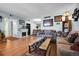 Cozy living room with hardwood floors, a fireplace, and comfortable seating around a wooden coffee table at 3550 S Harlan St # 174, Denver, CO 80235