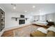 Spacious basement featuring a fireplace, a tv, an olive green sofa, and a bed with white linen at 7160 Canosa Ct, Westminster, CO 80030